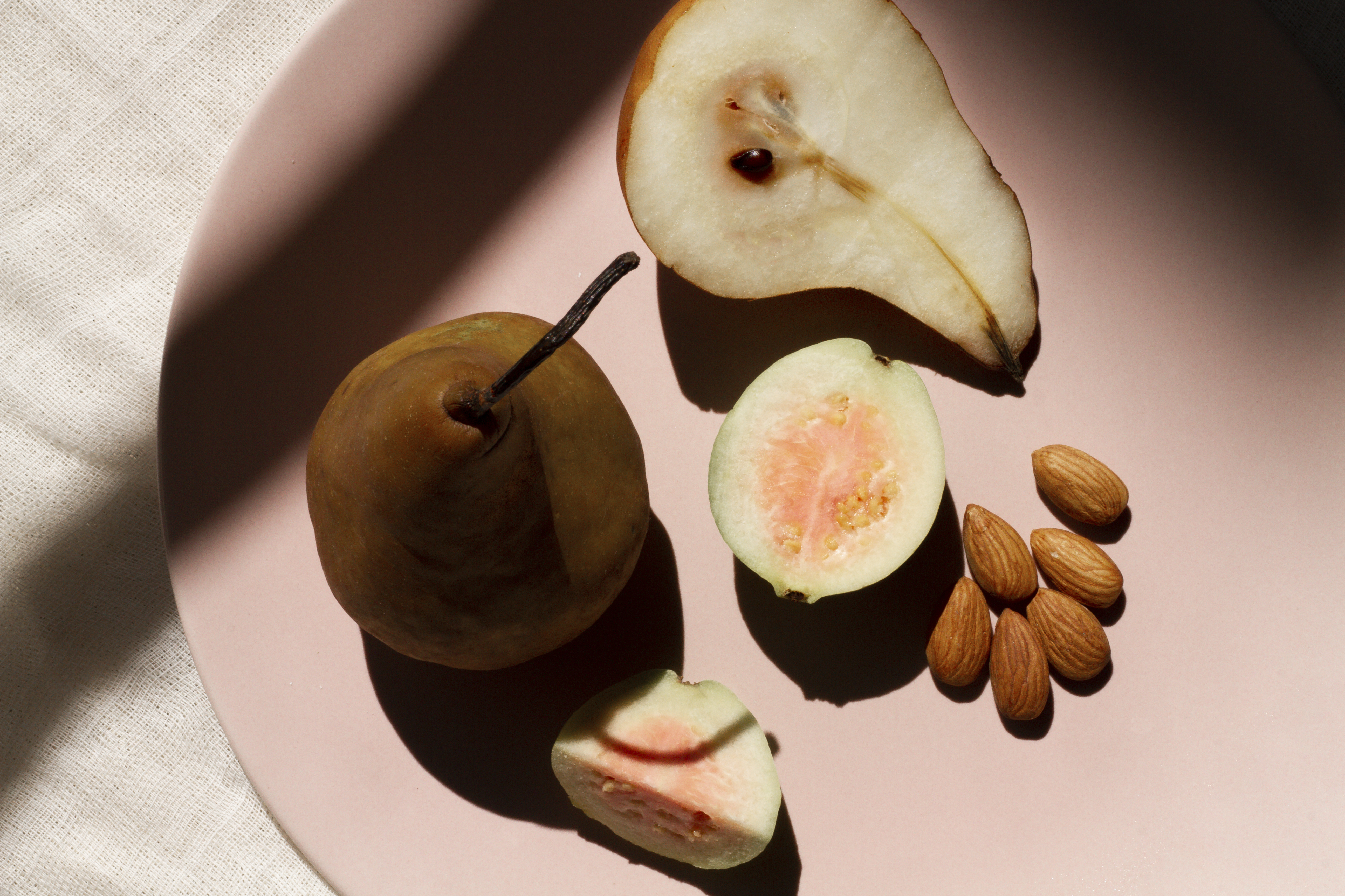 Fresh fruits and almonds on a plate